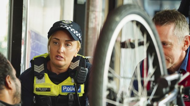 Police and Salvation Army members from Operation Brightside refer people begging on Elizabeth Street to support services.