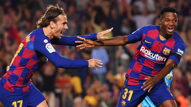 Sensation: Anssumane Fati of Barcelona, aged 16, celebrates with Antoine Griezmann after scoring his team's first goal during the Liga match against Valencia CF at Camp Nou.