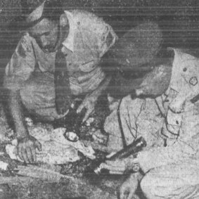 Photo from the original front page of the SMH showing Sgt. Henderson and Major Morton examining the unexploded shell. 22 March 1959.
