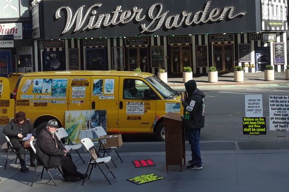 Preacher Brian Kelly, rights, carries on in locked down New York City.