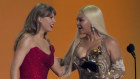 Taylor Swift presents the award for best country album to Beyonce at the Grammys.
