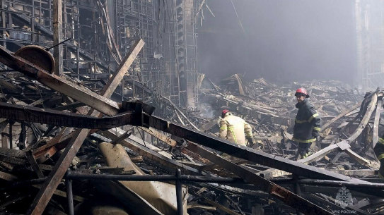 Russian emergency services personnel search through wreckage at the Crocus City Hall in Moscow.