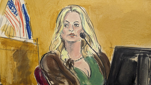 Stormy Daniels testifies as a promotional image for one of her shows is displayed on a monitor.