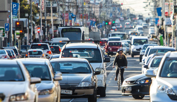 A cyclist making their way along Sydney Road, one of the most dangerous routes in the city.