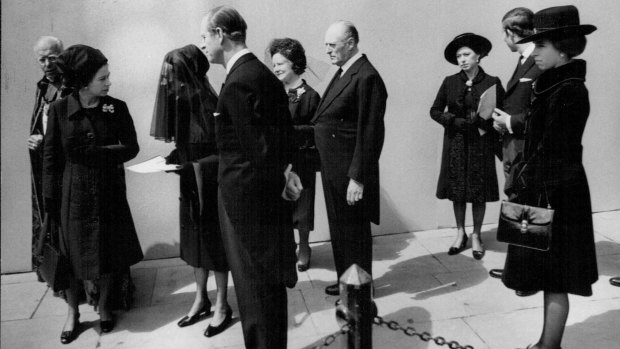 The Queen (second from left) speaks with the exiled Duchess of Windsor at Edward VIII’s funeral in London.