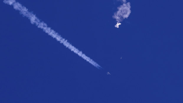 Büyük balonun kalıntıları, bir ABD savaş uçağı ve onun altında görünen iziyle Atlantik Okyanusu üzerinde sürükleniyor.