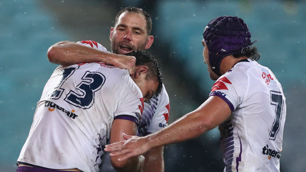 Cameron Smith and the Storm celebrate Tino Faasuamaleaui's crucial try on Friday night.
