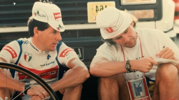 Simpler times: Taking notes from Stephen Roche, left, while sitting on the side of the road.