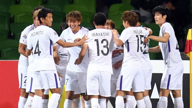 Off the mark: Taishi Matsumoto (third from left) reacts after opening the scoring for Hiroshima.