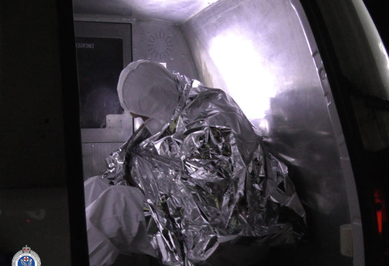 Police transport the men into custody on Sunday night