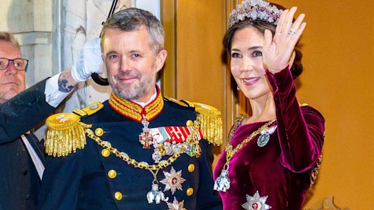 Crown Prince Frederik and Crown Princess Mary brave the rain.