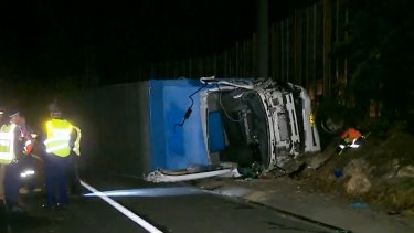 after truck crash trucks motorway m1 sydney its dead north freed rolled driver but accident pacific metres died scene another