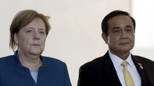 German Chancellor Angela Merkel, left, and Thailand's Prime Minister Prayut Chan-o-cha arrive for a joint statement in Berlin.