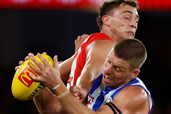 Will Hayward of the Swans and Aidan Corr of the Kangaroos compete for the ball.