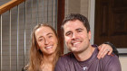Ben and Laura Mackenzie outside their home in Brisbane.