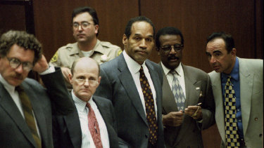OJ Simpson (centre) is shown with members of his defence team as the jury enters the court in 1995. Alan Dershowitz is at far left. 