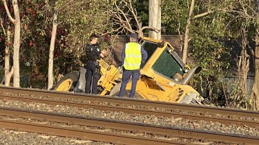 The crashed front-end loader in the rail corridor in Ipswich, south-west of Brisbane.