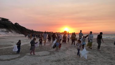 A large group of community members gathered in Byron Bay on Sunday for a candlelight vigil in honour of Theo Hayez, who has not been found.