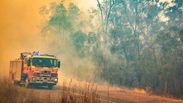 Firefighters work to control a bushfire in Deepwater, central Queensland, on November 30, 2018