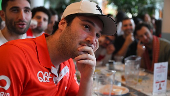 Swans fan Ben Wellek watches the AFL grand final at the Clovelly Hotel in Sydney.