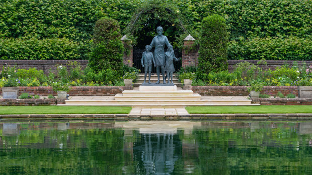 The statue of Diana, Princess of Wales, sits by the lake in the Sunken Garden at Kensington Palace.  