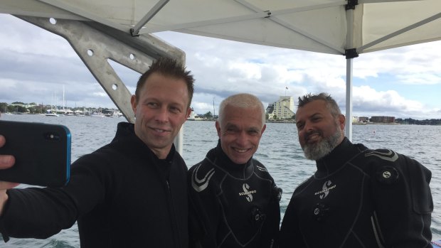 Vice-Admiral Mike Noonan, left, and divers from Australian National Maritime Museum Kieran Hosty, centre, and Dr James Hunter.