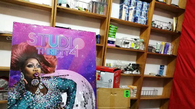 Pay-A-Sack-Forward\'s storage area, alongside a board featuring RuPaul\'s Drag Race contender Latrice Royale.