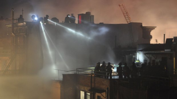 Firefighters battling the fire in the Harlem neighbourhood of New York, where firefighter Michael R. Davidson perished.