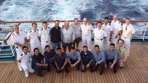 Pacific Dawn crew with the rescued men, top row, centre.