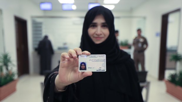 Tahani Aldosemani, Assistant Professor at Prince Sattam Bin Abdulaziz University in Al-Kharj, displays her brand new driving license, at the General Department of Traffic in the capital, Riyadh.