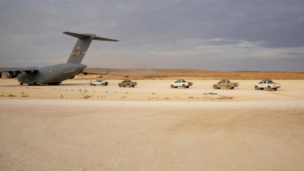 American vehicles line up to be loaded onto a cargo plane as part of the deliberate withdrawal of coalition forces from northern Syria last week.