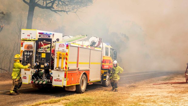 Firefighters working to control a bushfire in Deepwater, central Queensland.