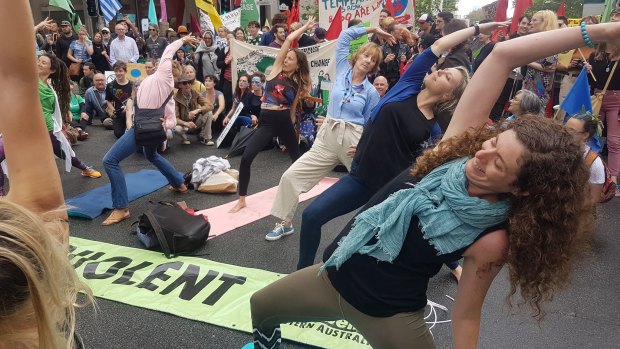 Protesters express their concerns about the climate with yoga.