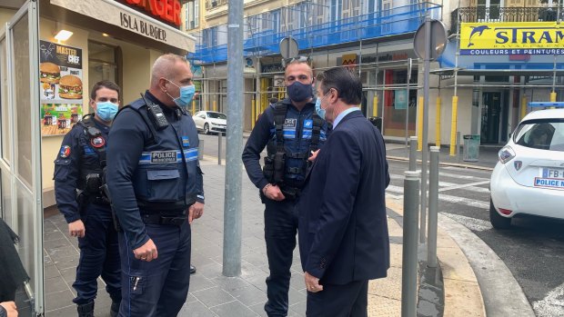 Christian Estrosi, the mayor of Nice, speaks to police at the scene of the attack.