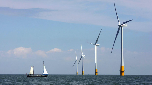 A vessel sails towards a wind farm off the coast of Whitstable on the north Kent coast in England.
