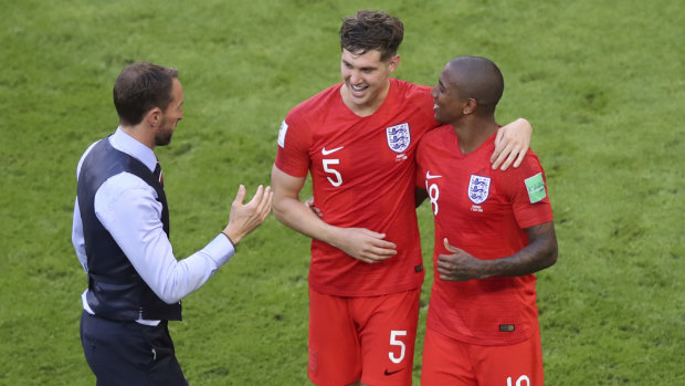 Gareth Southgate with John Stones and Ashley Young as they celebrate their quarter-final win.