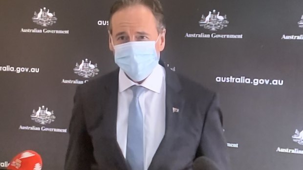 Health Minister Greg Hunt donned a face mask on Monday and exuded calm about the healthcare system's ability to cope.