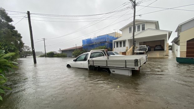 Flood waters make for treacherous driving in Narrabeen to Sydney's north.