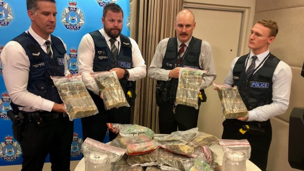 Police show off just some of the seized cash from recent days.