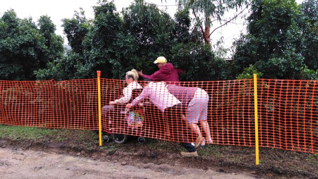 Residents helped a lady who got bogged while navigating around footpath construction at Forest Lake.