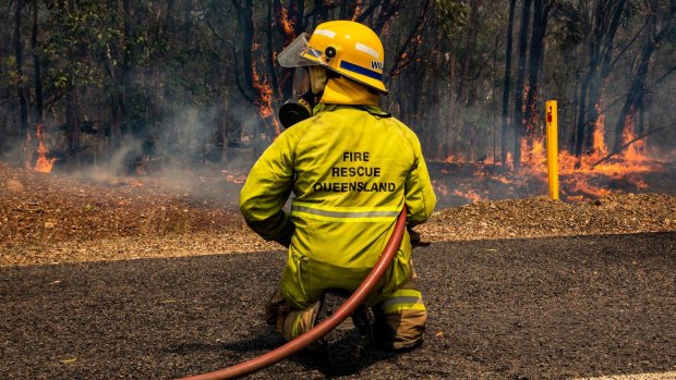 A firefighter battles the Deepwater bushfire. Residents have just been allowed to return home.