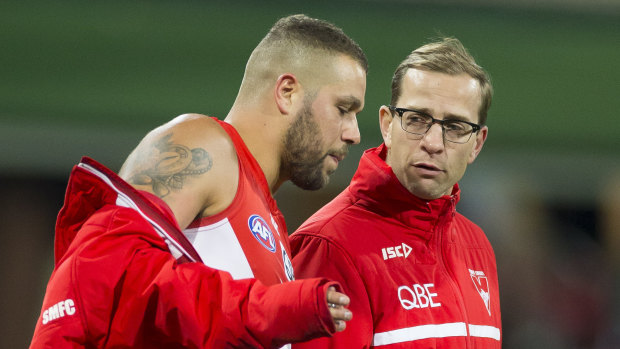 Sticky situation: Lance Franklin speaks to Sydney's head of football Charlie Gardiner after injuring his hamstring against Hawthorn.