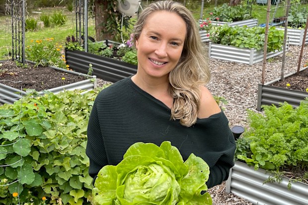 Gardener Sarah Rani with a head of lettuce grown in her garden.