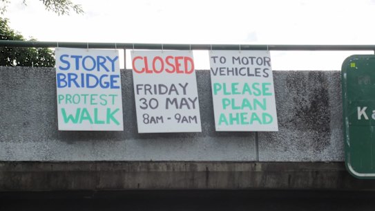 Signs went up on the Story Bridge warning of the protest on Friday.