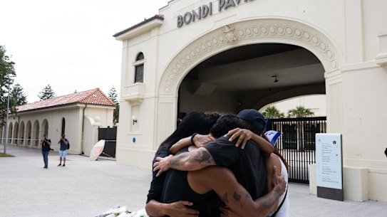 Flowers being lay flowers outside Bondi Pavillion.
