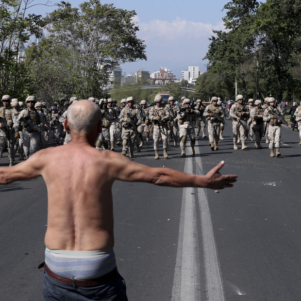 A man challenges soldiers during clashes in Santiago.