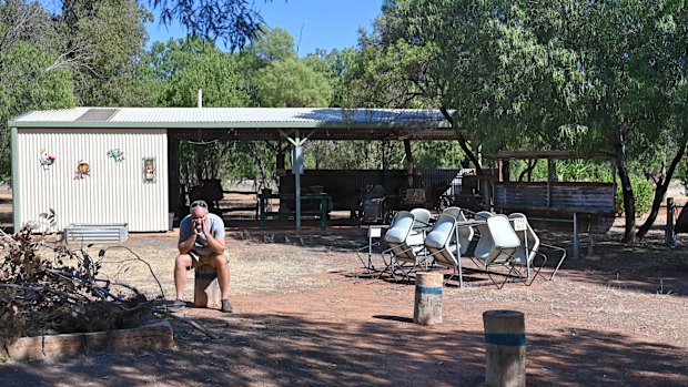 Charleville Bush Caravan Park operator 66-year-old Matthew Bom sits near his site’s empty fire pit area. Each night, he would usually be surrounded by travellers sharing their stories, but not this year. 