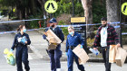 Forensic officers gather evidence at the university.