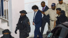 Sam Bankman-Fried, centre, is escorted out of the Magistrate Court building the day after his arrest in Nassau, Bahamas.