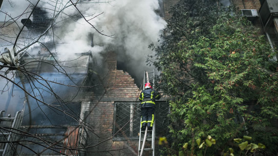 Firefighters work to put out a fire after two residential buildings were hit in the Pecherskyi district in Ukraine’s capital Kyiv as nationwide air alerts sounded.